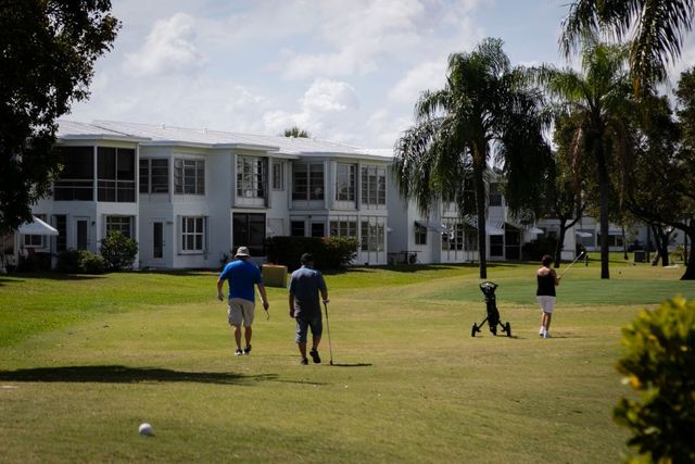 Seniors play golf at Leisureville, an age-restricted senior community, in Pompano Beach, FL.