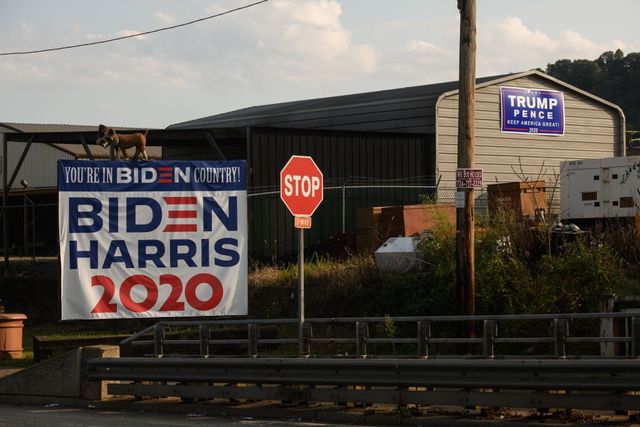 Dueling campaign signs for the Republican and Democratic candidates sit out in Braddock, PA. 