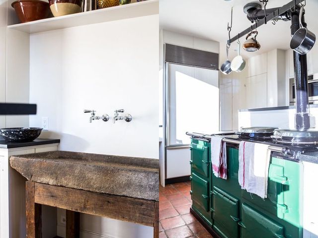 A stone trough used as a sink is original to the house The owners replaced the kitchen countertops.