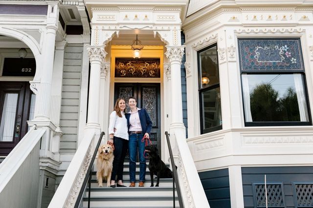 Jennifer Tobits (left) and wife Sarah Piepmeier, with their dogs Eleanor and Hunter, in front of their Victorian home.