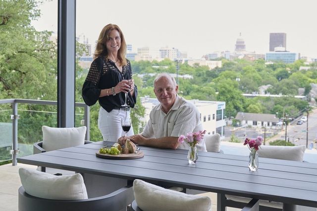 Dan and Sylvia Sharplin in the outdoor living space of their home with its view of the Texas State Capitol.
