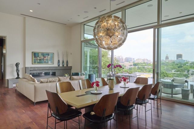 The living and dining area of the Sharplin home in Austin has sliding glass doors and 14-foot-high ceilings.