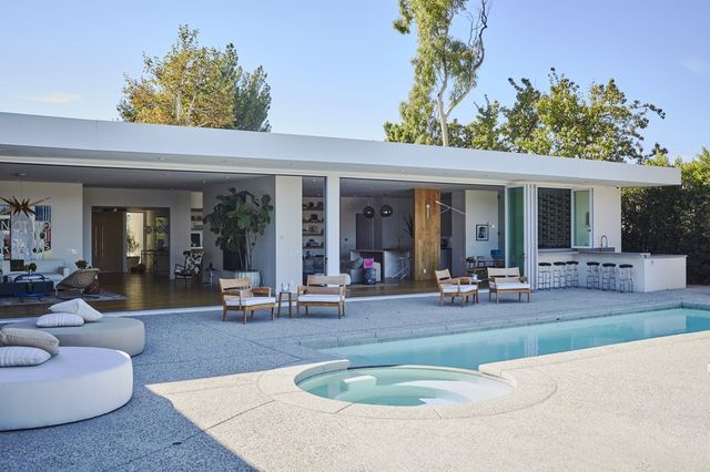 This home in Beverly Hills, Calif., has classic modern features like a flat roof, large windows, white or monochromatic interiors and industrial materials like concrete and steel.