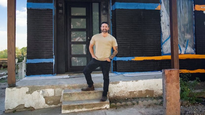 Rico León stands outside a partially renovated home on "Rico to the Rescue."